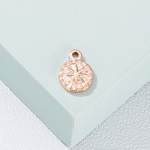 Rose gold stainless steel necklace pendant with starburst engraving and beaded edges