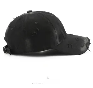 Side view of a vintage black distressed cotton baseball cap with torn texture details