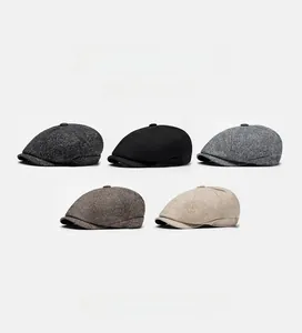 Detail view of newsboy caps in five colors showing thick wool blend fabric texture
