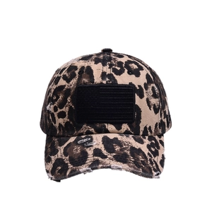 Distressed leopard print baseball cap with American flag patch and worn-out details