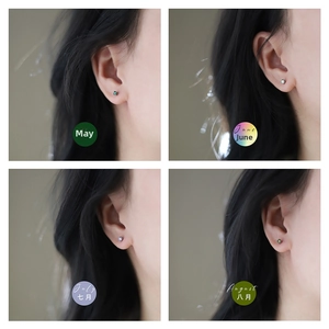 Macro details of four birthstone stud earrings in silver minimalist four-claw settings