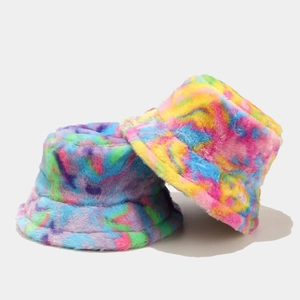 Close-up of thick plush tie-dye bucket hats showing soft faux fur texture and vibrant colors