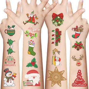 Macro shot of waterproof Christmas temporary tattoos on arms featuring Santa and reindeer