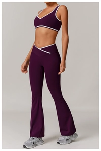 Detail of high-waisted crossover yoga leggings with contrast piping and V-neck sports bra