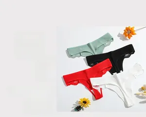 Flat lay of ribbed cotton thongs with lace trim in mint, black, red and white colors