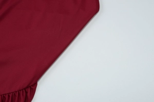 Close-up of wine red ruffled fabric detail with high-quality texture for summer dress