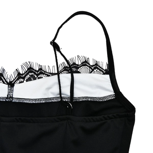 Detailed close-up of the black eyelash lace trim and fine straps on this sexy mini dress