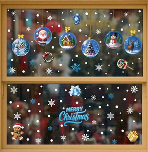 Detail view of festive Santa and snowman glass stickers on a wooden window pane