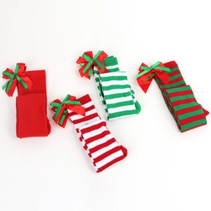 Detail view of assorted Christmas over-knee socks with festive stripes and ribbon bows