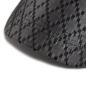 Close-up of grey and black geometric jacquard fabric on a stylish baseball cap brim