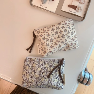 Detail view of floral cotton linen coin purses with zipper closure and decorative cord