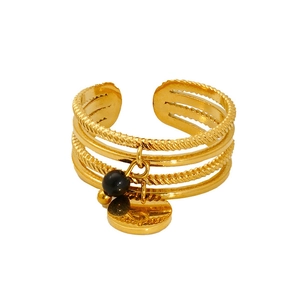 Detailed macro view of 18K gold-plated multi-layer adjustable ring with black bead charm