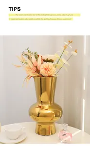 Detailed macro view of the handcrafted golden electroplated ceramic vase with artificial bouquet