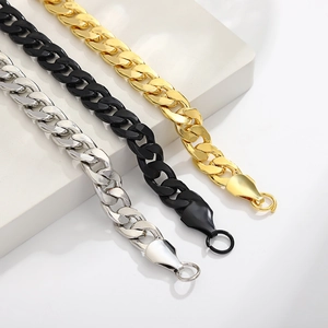 Cuban link bracelets in gold, black, and silver finishes displayed on white pedestals