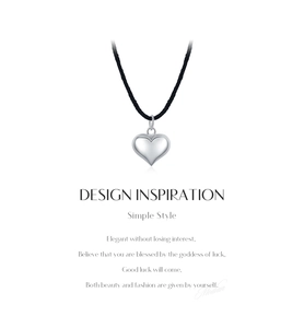 Detail view of s925 sterling silver heart pendant on a black cord with text overlay