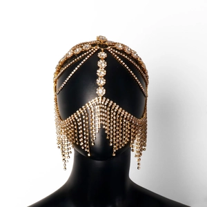 Luxury ethnic fringe face mask with gold rhinestones and crystals on a black mannequin