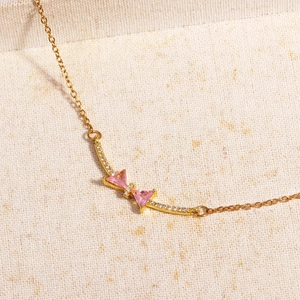 Elegant 18K gold plated bow necklace featuring pink zircon stones and fine chain
