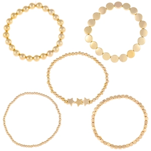 Set di 5 braccialetti con perline dorate, ciondoli a stella e piccoli dischi metallici