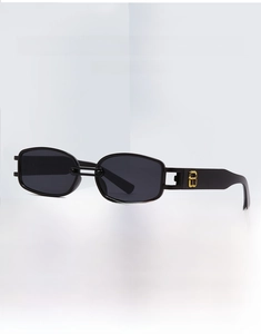 Detail of black rectangle sunglasses with golden metal logo on clean geometric stand