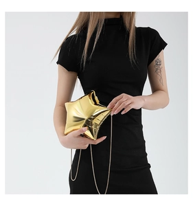 Detailed view of a gold star-shaped acrylic evening bag with a sleek metallic mirror finish