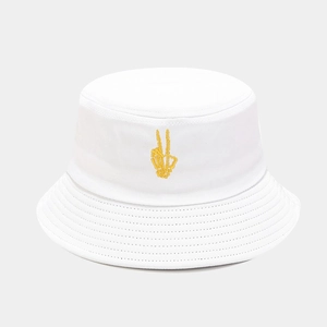 Detail of yellow skull hand embroidery on white cotton bucket hat with parallel stitching
