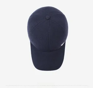 Detailed top view showing the navy wool fabric texture and metal trim of the baseball cap