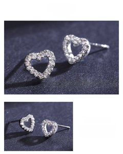Detail shot of heart-shaped S925 silver stud earrings with sparkling cubic zirconia stones