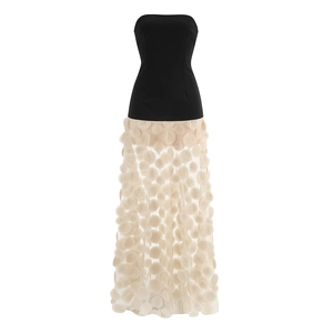 Detailed view of 3D floral appliques and white polka dot mesh on an elegant black dress