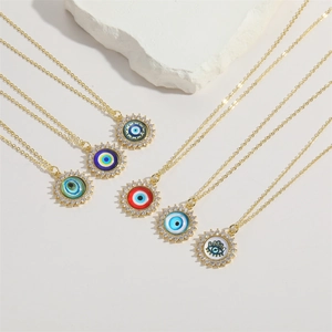 Detail of six colorful resin evil eye pendants with gold chains and zircon accents