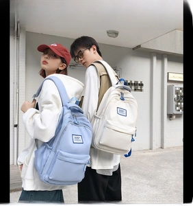 Street style view of high capacity waterproof school backpack in light blue and white
