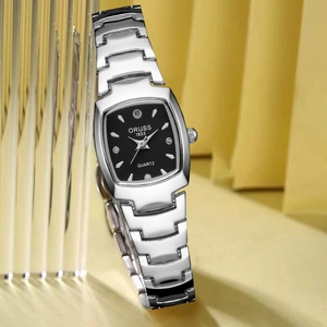 Close-up of elegant square black dial watch with rhinestone markers and silver steel band