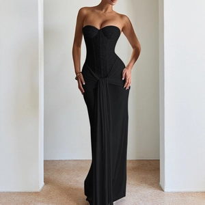 Detail of elegant black strapless evening dress with corset bodice and draped satin skirt
