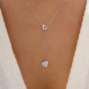 Close-up of S925 silver Y-necklace with double heart pendants and sparkling diamonds on neck