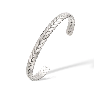 Macro detail of silver geometric open cuff bracelet with polished braided wheat pattern