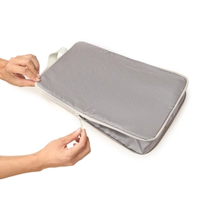 Detail view of grey ripstop fabric travel organizer bag with smooth zipper and handle