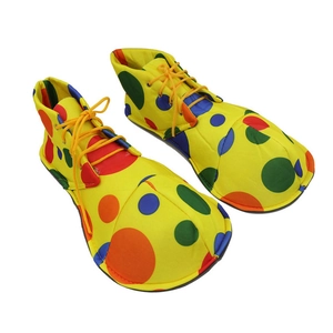 Top-down view of vibrant yellow clown shoes featuring colorful polka dots and fabric laces