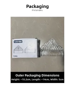 Detail view of crown-shaped crystal glass napkin holder with its white packaging box