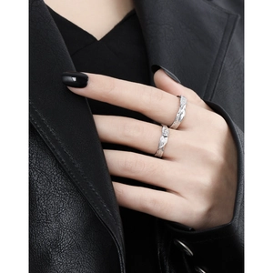 Textured S925 sterling silver couple rings with diamond accents on a model's hand