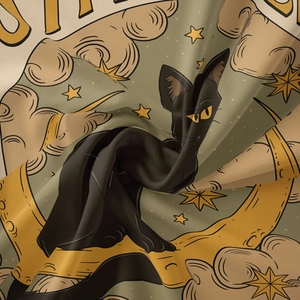 Detail of vintage bohemian tapestry fabric showing a black cat sitting on a golden moon