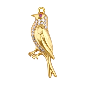 Detail view of gold-plated bird pendant with sparkling rhinestones and a ruby eye