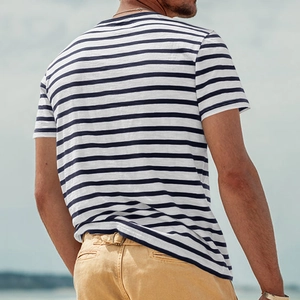 Rear side view of a men's navy striped cotton t-shirt worn outdoors for a casual look