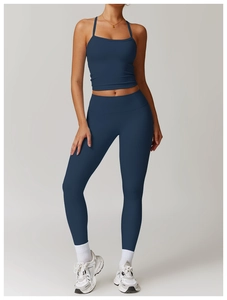 Full view of deep blue brushed yoga vest and high-waist leggings on studio model