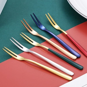 Set of colorful stainless steel dessert forks in gold, rose gold and blue finishes