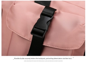 Close-up of durable black buckle and pink waterproof fabric on a versatile travel bag