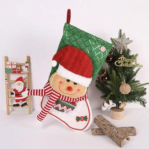 Detail of gingerbread man Christmas stocking with sequins and a red hanging loop