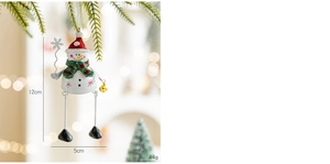 Close-up of a Christmas snowman hanging ornament with long metal legs on a festive tree