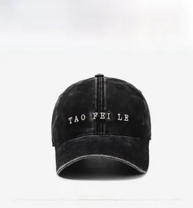 Detailed front view of black washed cotton baseball cap with white 3D letter embroidery