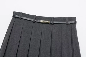 Close-up of dark grey pleated skirt shorts with black belt and gold metal buckle