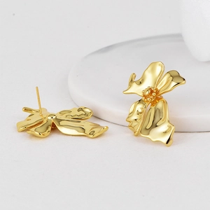 Elegant gold brass flower stud earrings with concave petal texture on a minimalist base