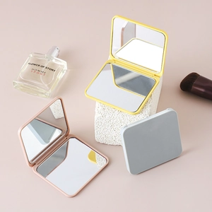 Portable folding makeup mirrors in yellow, pink and grey with dual-sided glass